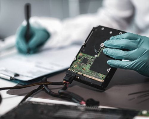 Forensic Science Investigator Examining Computer Hard Drive. Digital Forensic Science Concept.